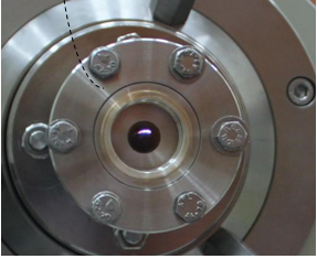 A photograph showing the optical part of synchrotron beam passing through XAS and MCD chambers and as seen towards the end of MCD station as marked by an arrow 