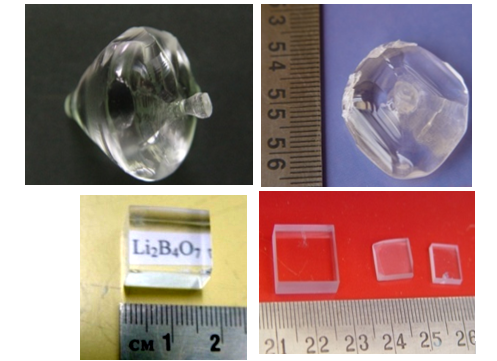 Undoped and doped Lithium Tetra Borate single crystals (top row) grown using Czochralski technique and the fabricated elements (right image in bottom row) [Cryst. Growth Des. 8 (2008) 4424-4427; Cryst. Res. Technol. 44 (2009) 305-308; Cryst. Res. Technol. 44 (2009) 1303-1307]